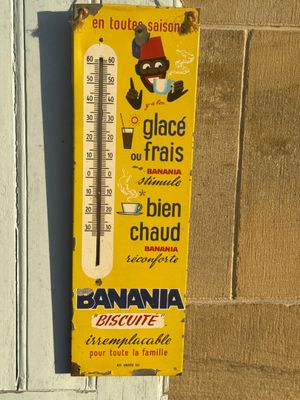 a thermometer hanging on the wall of a building