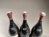 three bottles of wine sitting next to each other on a table