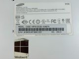 the back of a white laptop with a sticker on it ' s side