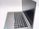 a silver laptop computer sitting on top of a white table