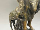 bronze statue of a woman with a goat on a marble base