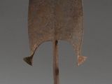 an image of a wooden sculpture of a leaf on a metal base