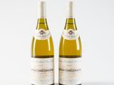 two bottles of wine sitting next to each other on a white surface