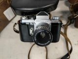 a camera that is sitting on a table with a strap around it