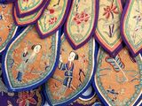 a lot of different colored rugs on a table