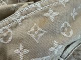 a close up of a pair of jeans with a tie