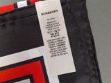 a close up of a black and red bag with a tag on it