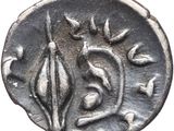 a silver coin with leaves and flowers on it