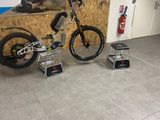 a bike that is sitting in a room with a ladder