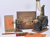 an old fashioned sewing machine with a box and papers on a table