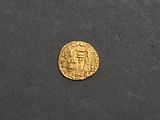 a gold coin with an image of a man and a woman on it