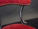 a red chair that is sitting on a black table