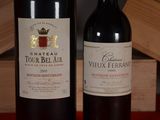 two bottles of wine sitting next to each other on a table
