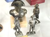three figurines that are on display in a glass case