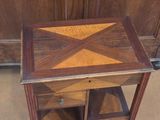 a small wooden table with a drawer underneath it