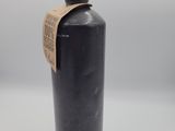 a black water bottle sitting on top of a white table