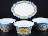 three bowls and a plate on a black surface