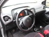 the interior of a small car with a steering wheel and dashboard