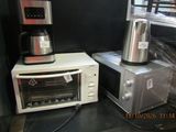 two microwaves and a toaster on display in a store
