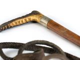 a pair of scissors and a cane on a white surface