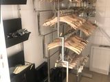 a lot of clothes hanging on a rack in a room