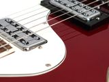 a close up of a red and white electric guitar