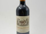 a bottle of red wine sitting on top of a white table