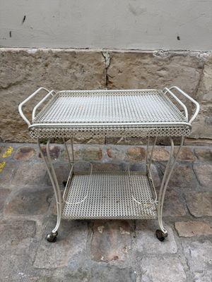 a metal table that is sitting on a stone floor