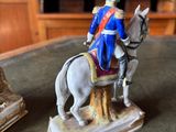 a figurine of a man riding a horse on a table