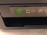 a close up of a printer on a wooden table