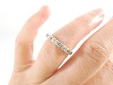 a woman ' s hand with a diamond ring on it