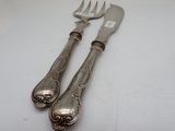 two forks and a knife sitting on a table