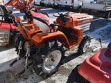a small tractor that is parked in a parking lot