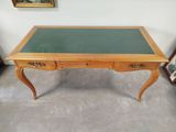 a small table with a green top on a carpeted floor