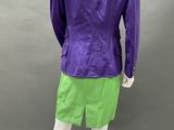 the back view of a mannequin wearing a purple jacket and green shorts