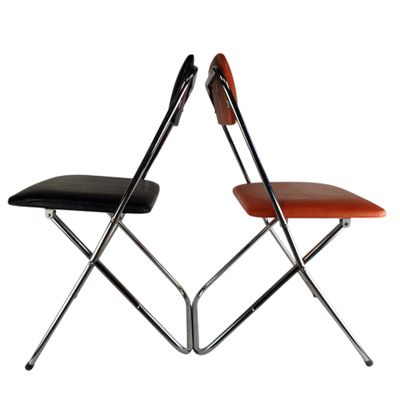 two folding chairs with black and orange leather seats on a white background
