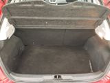 a trunk of a red car with its trunk open