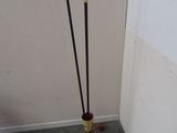 two poles that are standing in the corner of a room