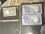 several different types of currency are sitting on a table