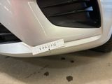 a close up of a white car with a sticker on it
