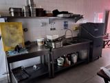 a kitchen with a sink, stove, and other items on the counter
