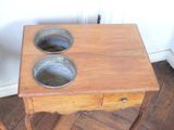 a small wooden table with two bowls on top of it