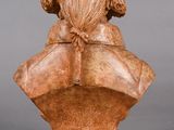 an image of a wooden bust of a woman with long hair
