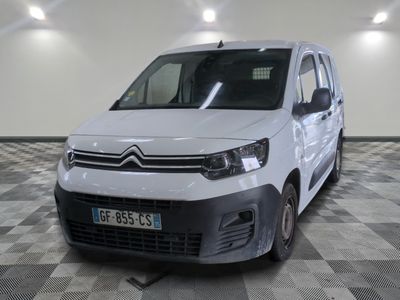 la camionnette blanche est garée dans une grande pièce au sol en damier