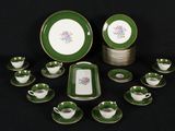 green and white porcelain dinnerware set with matching cups and saucers