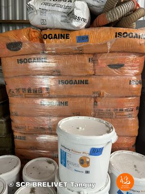 several buckets of cement sitting on top of a table next to a pile of bags