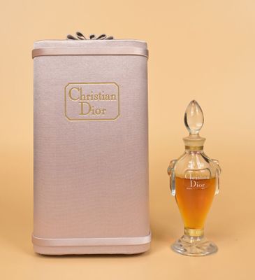 christian dior perfume bottle next to a small glass perfume bottle