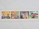 four different stamps with cartoon characters on them on a white surface