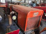 many old tractors in a large building with a lot of them