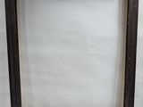 an old picture frame sitting on top of a white surface